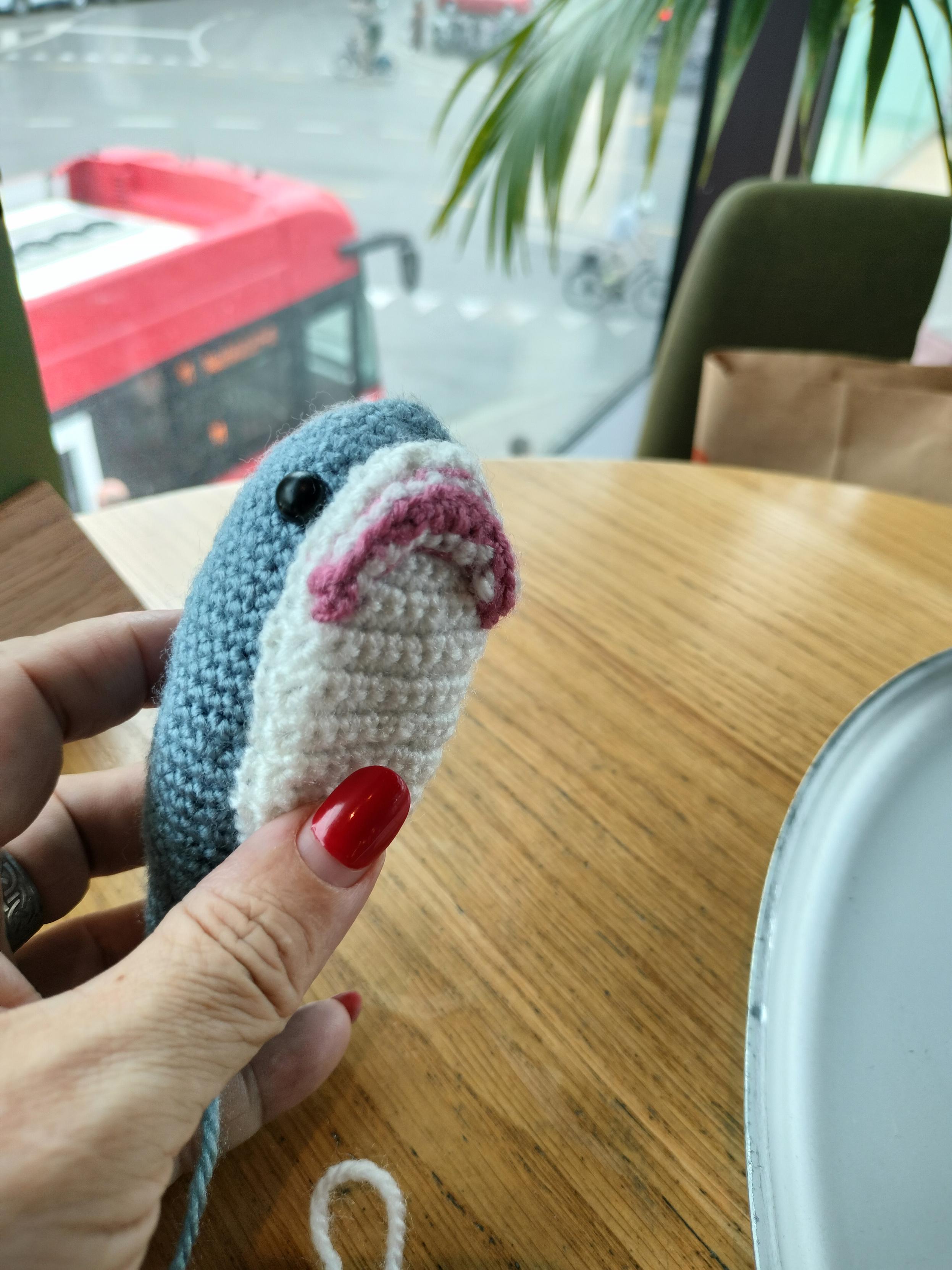 A crocheted Blåhaj with attached belly and mouth.